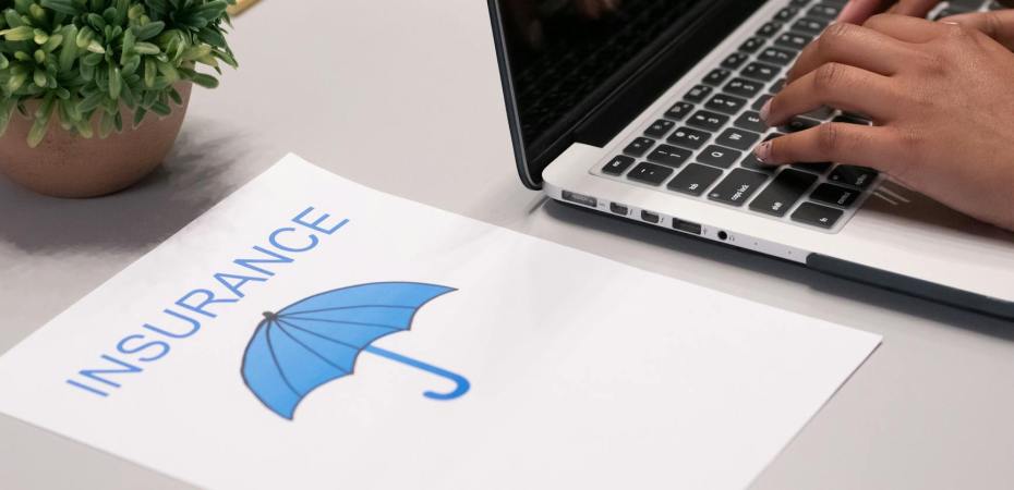 a paper beside a person typing on a laptop