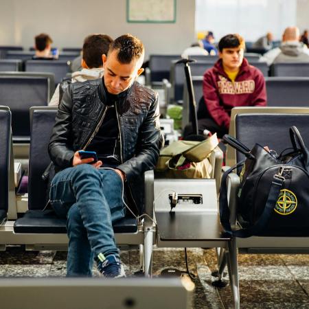 man in black leather jacket sitting on chair