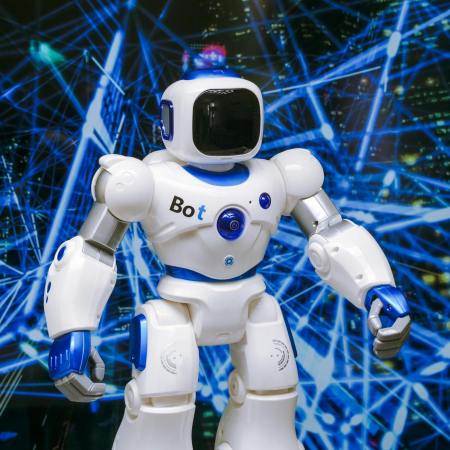 white robot action figure on blue string lights