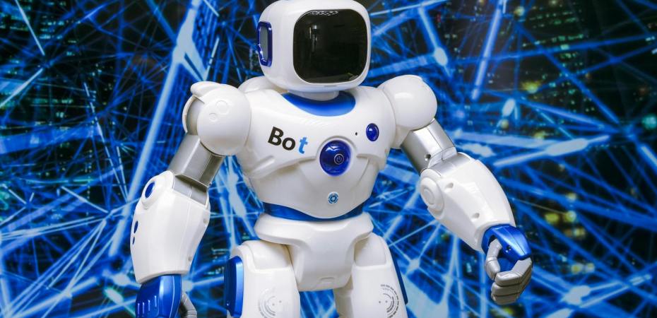 white robot action figure on blue string lights