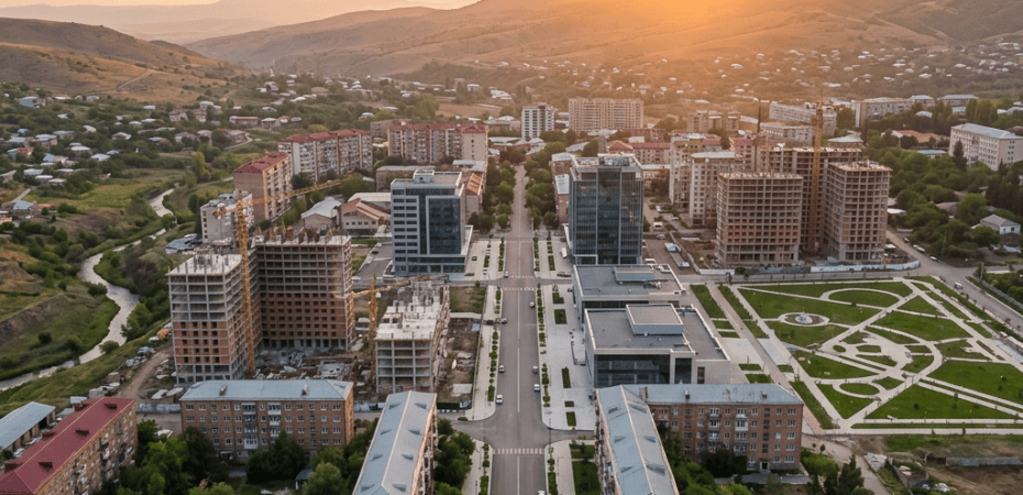 Aerial view of a city district with mountains at sunset