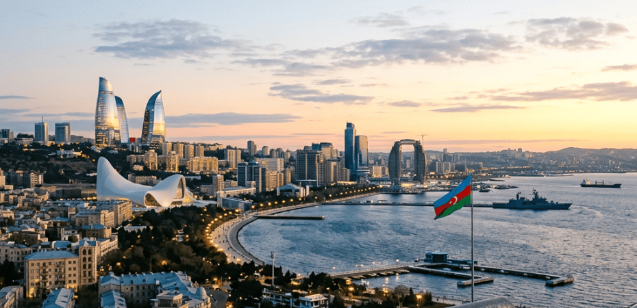 Baku skyline and waterfront with Azerbaijan flag at sunset